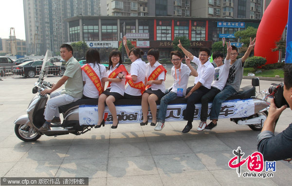 A 5.2 meters long electric bicycle, has 8 seats, appears during the 31th(2010) China Zhejiang International Bicycle Electric-Cycle Exhibition at Hangzhou Peace International Exhibition and Conference Center on October 9, 2010 in Hangzhou, southeast China&apos;s Zhejiang Province. [CFP]