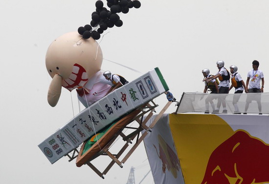 A participant rides in a self-made flying craft during the Red Bull Flugtag (Flight Day) event at West Kowloon Heliport in Hong Kong October 10, 2010. Forty teams competed to build a craft capable of flying the furthest without the use of an engine.[China Daily/Agencies]