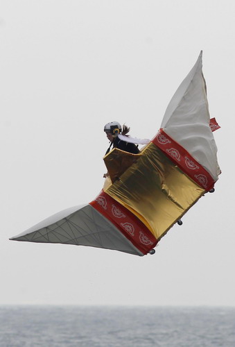 A participant rides in a self-made flying craft during the Red Bull Flugtag (Flight Day) event at West Kowloon Heliport in Hong Kong October 10, 2010. Forty teams competed to build a craft capable of flying the furthest without the use of an engine.[China Daily/Agencies]