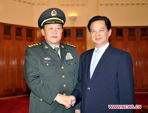 Vietnamese Prime Minister Nguyen Tan Dung (R) shakes hands with Chinese Defense Minister Liang Guanglie in Hanoi, Vietnam, Oct 11, 2010. Chinese Defense Minister Liang Guanglie arrived here Sunday to attend a regional security conference and visit Vietnam. [Huang Xiaoyong/Xinhua]