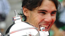 Rafael Nadal of Spain bites the trophy during the awarding ceremony for the men's singles of the Japan Open tennis tournament in Tokyo, Japan, Oct. 10, 2010.