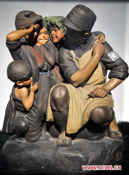 Photo taken on Oct. 10, 2010 shows a painted sculpture works during an exhibition of Zhang Naiying, the fifth-generation successor of Clay Figure Zhang, at the National Art Museum of China in Beijing, capital of China.