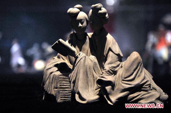 Photo taken on Oct. 10, 2010 shows painted sculpture works during an exhibition of Zhang Naiying, the fifth-generation successor of Clay Figure Zhang, at the National Art Museum of China in Beijing, capital of China.