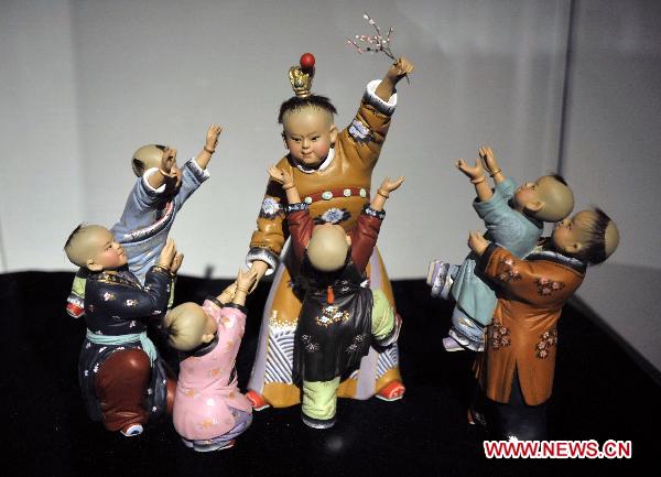 Photo taken on Oct. 10, 2010 shows painted sculpture works during an exhibition of Zhang Naiying, the fifth-generation successor of Clay Figure Zhang, at the National Art Museum of China in Beijing, capital of China.