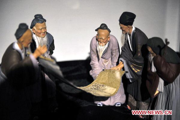 Photo taken on Oct. 10, 2010 shows painted sculpture works during an exhibition of Zhang Naiying, the fifth-generation successor of Clay Figure Zhang, at the National Art Museum of China in Beijing, capital of China.