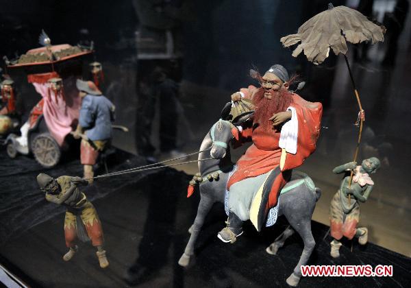 Photo taken on Oct. 10, 2010 shows painted sculpture works during an exhibition of Zhang Naiying, the fifth-generation successor of Clay Figure Zhang, at the National Art Museum of China in Beijing, capital of China.