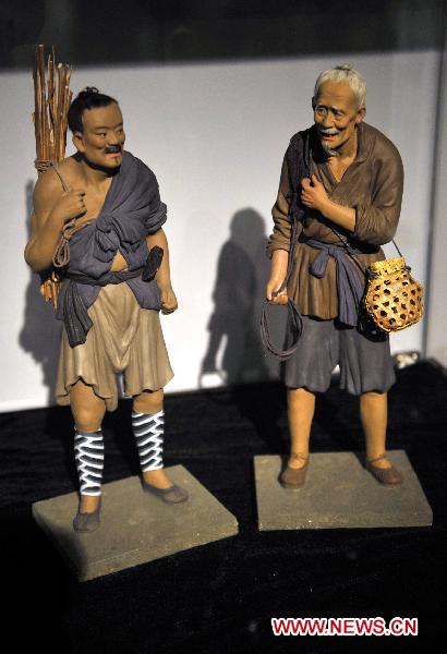 Photo taken on Oct. 10, 2010 shows painted sculpture works during an exhibition of Zhang Naiying, the fifth-generation successor of Clay Figure Zhang, at the National Art Museum of China in Beijing, capital of China.