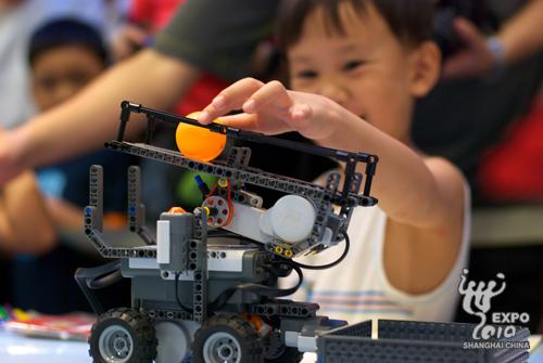  A Chinese child is seen behind a robot in the games.