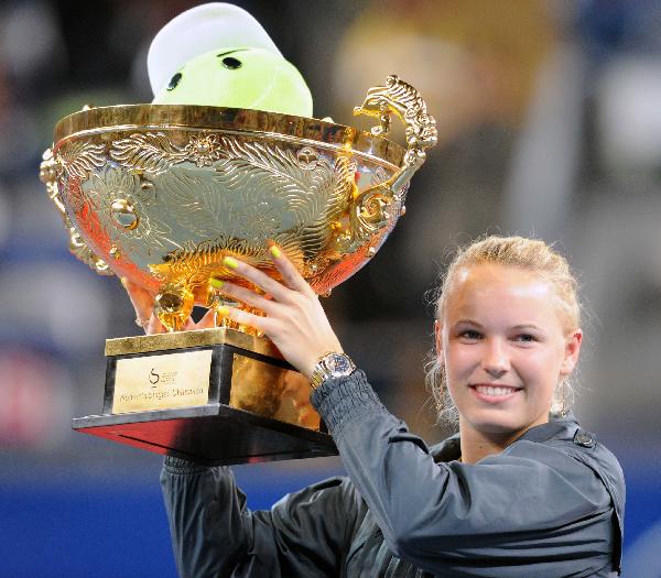 Caroline Wozniacki of Denmark lifts up the champion trophy during the awarding ceremony after her final of women&apos;s singles against Vera Zvonareva of Russia in 2010 China Tennis Open Tournament at Lotus Court in National Tennis Center in Beijing, capital of China, Oct. 11, 2010. Wozniacki won 2-1 and claimed the title of the event. [Xinhua] 