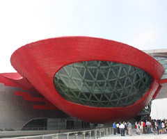 The Historic Museum, whose red 'shell' highlights the Asian Games Town Gymnasium.[Jessica Zhang/China.org.cn]