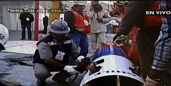 This video grab shows rescuers and technicians checking the Fenix capsule, before starting the rescue operation of the 33 trapped miners, at the San Jose mine, in Copiapo, Chile, October 12, 2010. [Xinhua] 