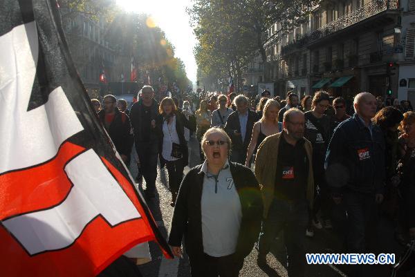 Protesters walk near the Bastille Square to protest against President Nicolas Sarkozy's plan to raise the retirement age up to 62 in Paris, France, Oct. 12, 2010. (Xinhua/Zhang Yina)