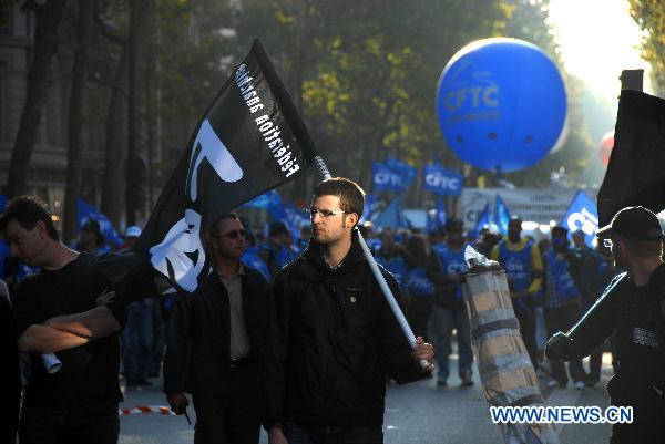 Protesters walk near the Bastille Square to protest against President Nicolas Sarkozy's plan to raise the retirement age up to 62 in Paris, France, Oct. 12, 2010. Protesters walk near the Bastille Square to protest against President Nicolas Sarkozy's plan to raise the retirement age up to 62 in Paris, France, Oct. 12, 2010. [Xinhua/Zhang Yina]