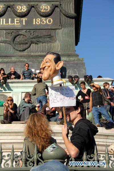 Protesters gather at the Bastille Square to protest against President Nicolas Sarkozy's plan to raise the retirement age up to 62 in Paris, France, Oct. 12, 2010. Protesters walk near the Bastille Square to protest against President Nicolas Sarkozy's plan to raise the retirement age up to 62 in Paris, France, Oct. 12, 2010. [Xinhua/Zhang Yina]