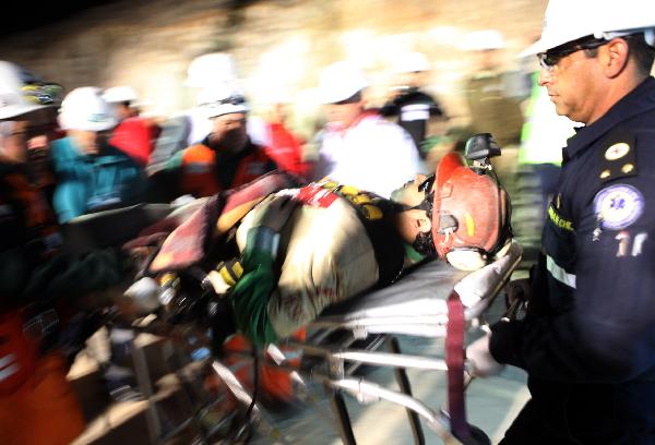 In this image released by the government of Chile, The first miner Florencio Avalos is attending by rescue team at the San Jose mine in Copiapo, Chile, Oct. 12, 2010. The operation to lift out the 33 miners trapped for over two months in northern Chile is under way right now. [Jose Manuel de la Maza/Xinhua//Government of Chile]