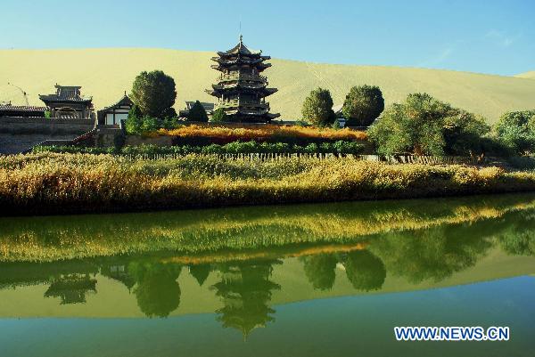 Photo taken on Oct. 12, 2010 shows the autumn scenery of Crescent Moon Spring at the Singing Sand Mountain in Dunhuang City, northwest China's Gansu Province. [Xinhua/Zhang Weixian]