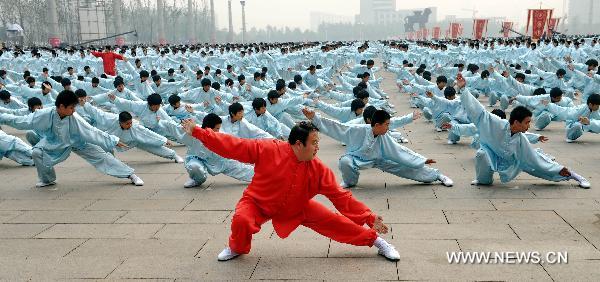 People perform traditional Chinese martial arts at Shicheng square of Cangzhou City, north China's Hebei Province, Oct. 10, 2010. The eighth Cangzhou International Martial Arts Festival was opened on Oct.9, 2010.