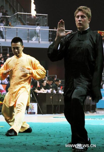 A Finland's player(Front) who lost his left hand competes during Taiji martial event at the eighth Cangzhou International Martial Arts Festival in Cangzhou City, north China's Hebei Province, Oct. 10, 2010.