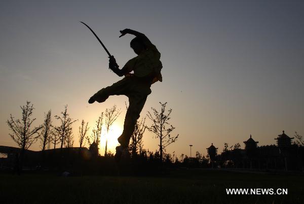 Wang Xiaoyang, 19 years old, practises during his preparation for the eighth Cangzhou International Martial Arts Festival in Cangzhou City, north China's Hebei Province, Sept. 29, 2010. The eighth Cangzhou International Martial Arts Festival was opened on Oct.9, 2010.