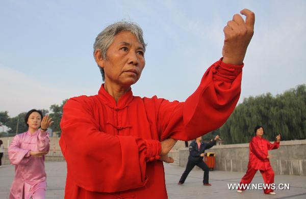 People practise Taiji martial in Cangzhou City, north China's Hebei Province, Sept. 24, 2010. The eighth Cangzhou International Martial Arts Festival was opened on Oct.9, 2010.