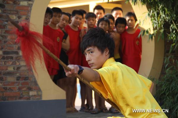 Wang Xiaoyang, 19 years old, shows his spear skill during his preparation for the eighth Cangzhou International Martial Arts Festival in Cangzhou City, north China's Hebei Province, Sept. 29, 2010. The eighth Cangzhou International Martial Arts Festival was opened on Oct.9, 2010. 