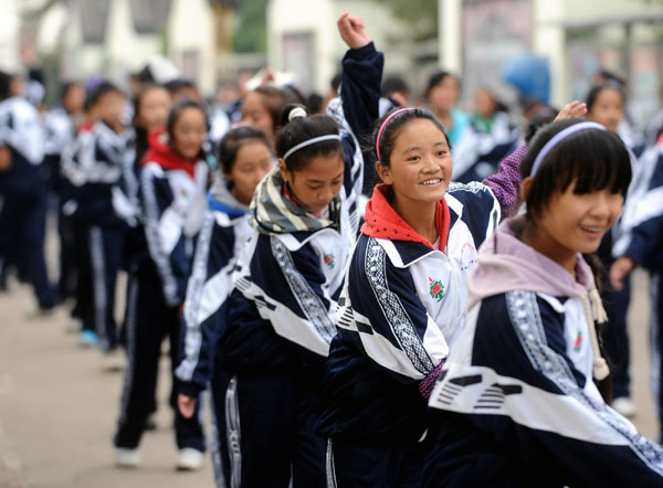 Students from the earthquake-hit Yushu in Northwest China's Qinghai province dance after class at their new school in Changzhi, North China's Shanxi province, Oct 12, 2010. More than 1,000 students were transferred to study for three years in Shanxi after the deadly earthquake hit Yushu in April.[Photo/Xinhua]
