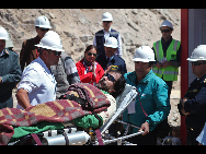 In this image released by the government of Chile, the fifteenth miner Victor Segovia is taken to hospital after being brought to the surface at the San Jose mine in Copiapo, Chile, Oct. 13, 2010. [Xinhua]