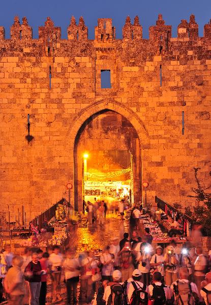 Foreign tourists pose for pictures outside the Damascus Gate of the Old City in Jerusalem on Oct. 13, 2010. According to Israel's Central Bureau of Statistics, since the beginning of the year, nearly 2.5 million tourists have visited Israel, an increase of 27 percent over the same period in 2009 and 9 percent over 2008, setting a new record to date. [Xinhua/Yin Dongxun]