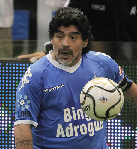 Former Argentina's national soccer team coach Diego Maradona prepares to kick the ball during a charity match for ex-soccer player Fernando Caceres in Buenos Aires October 16, 2010. (Xinhua/Reuters Photo)