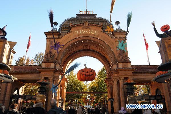 People visit the Tivoli amusement park in Copenhagen, Denmark, Oct. 16, 2010. The seasonal park opened to the public with the theme decoration of the upcoming Halloween. [Xinhua/Li Mu]