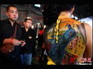 Artists from the United States, Australia, New Zealand and China display their personalized and creative tattoo works at the International Tattoo Arts Festival,which kicked off on October 15 at Beijing's 798 Art District. [Chinanews photo]