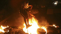 A Palestinian youth jumps over a fire during the clash with Israeli border police in the East Jerusalem neighbourhood of Silwan Oct. 17, 2010.