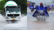 Vehicles wade through on waterlogged street in Haikou, capital of south China's Hainan Province, Oct. 17, 2010. The heavy rainfall in the city on Sunday caused severe waterlogging in some areas.