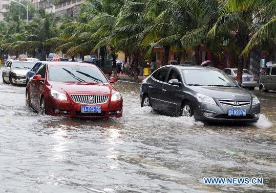 Vehicles wade through on waterlogged street in Haikou, capital of south China's Hainan Province, Oct. 17, 2010. The heavy rainfall in the city on Sunday caused severe waterlogging in some areas. [Xinhua]