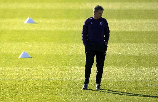 Real Madrid's coach Jose Mourinho stands on the pitch as he attends a training session at team's Valdebebas soccer ground in Madrid October 18, 2010, on the eve of their Champions League soccer match against AC Milan. (Xinhua/AFP Photo) 