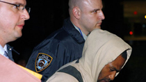 David Williams, one of four suspects arrested in an FBI sting operation, is escorted out of FBI offices in New York in this May 21, 2009 file photo.