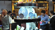 People visit a pavilion at the 2010 China Jingdezhen International Ceramic Fair in the porcelain town of Jingdezhen, east China's Jiangxi Province, Oct. 18, 2010.