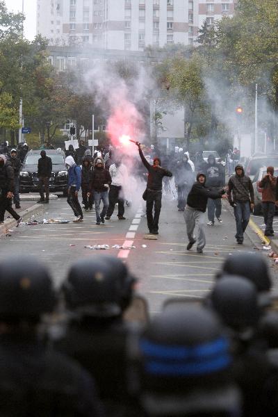 Students clash with the police during a demonstration over pension reforms with private and public sector workers in Lyon October 18, 2010. [Xinhua]