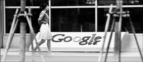 A woman walks in front of Google China's office in Beijing. Seven ad resellers said on Tuesday that they would take legal action against the search engine after the latter terminated contracts with them. 