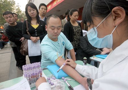 Residents donate blood in front of a hospital in Shangqiu, Henan Province, on October 13. 