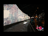 The animated remake of the famous Song Dynasty scroll painting, Along the River During the Qingming Festival, draws crowds to the already-popular China Pavilion at the Shanghai 2010 Expo. It spans 130 meters, with a height of 6.3 meters -- 30 times the original work. [Photo by Yang Dan]