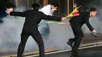 People rush out from the Millennium Seoul Hilton Hotel while taking part in the anti-terror exercises simulating a chemical weapons attack in Seoul, South Korea, on Oct. 20, 2010.