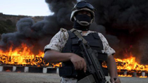 A Mexican military man guards the area where the 134 tons of marihuana are being cremated in a military base in Tijuana, Baja California, north of Mexico, on Oct. 20, 2010.