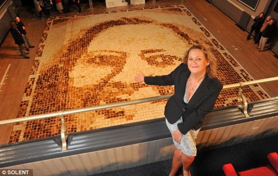 27-year-old museum curator Laura Hadland turned a photo of her mother-in-law into the world's largest toast mosaic - comprising 9,852 slices, the Daily Mail reports.