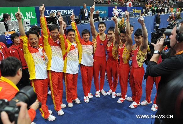 Chinese team members celebrate after winning the men's team final at the 42nd Artistic Gymnastics World Championships in Rotterdam, the Netherlands, Oct. 21, 2010. China won the gold medal with a total of 274.997 points. (Xinhua/Wu Wei)