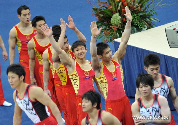 Chinese gymnasts walk to the podium during the awarding ceremony for the men's team final at the 42nd Artistic Gymnastics World Championships in Rotterdam, the Netherlands, Oct. 21, 2010. China won the gold medal with a total of 274.997 points. (Xinhua/Wu Wei)