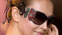 A model presents a pair of glasses named Moulin Rouge during a media conference for the 12th Hong Kong Eyewear Design Competition in Hong Kong, south China, Oct. 21, 2010.