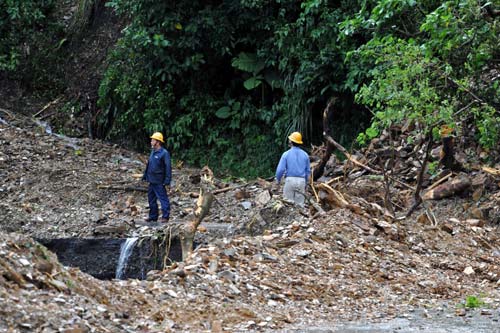 Rescuers work on a damaged road in Yilan county of Taiwan, Oct 22, 2010. 