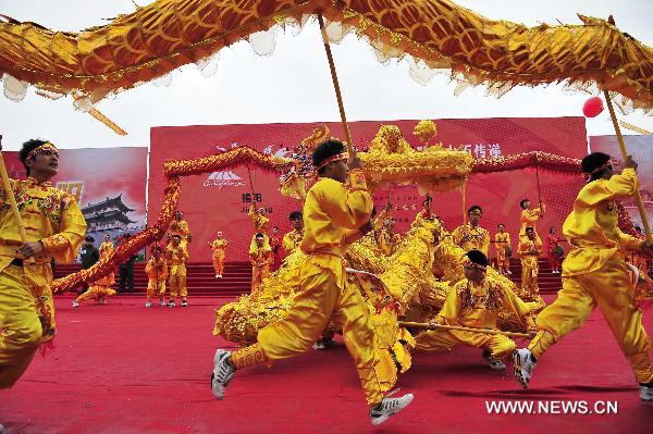 The Dragon Dance performance is seen during the inauguration ceremony of the torch relay for the 16th Asian Gmaes in Jieyang City, south China&apos;s Guangdong Province, Oct. 23, 2010. 