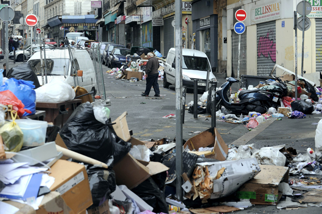 A child rides his scooter in front garbage piled on October 24, 2010 in a street of Marseille, as a result of a strike by rubish collectors since October 12 to protest against French President&apos;s bid to raise the retirement age. The pensions reform bill was approved by the Senate on October 22, and the text will be reconciled October 25 with the draft passed earlier by the lower house. However, strikes have continued across the industry. [Xinhua] 